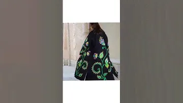 She was just divesting herself of a long camel-hair coat...